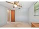 Bright bedroom featuring light blue walls, neutral carpet, ceiling fan, and closet at 3514 Truman Dr, Holiday, FL 34691