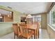 Open dining area with wood table, seating for six, and a view into another room at 3514 Truman Dr, Holiday, FL 34691