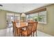 Cozy dining room features a wood table with seating for six and natural light from a large window at 3514 Truman Dr, Holiday, FL 34691