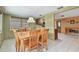 Dining area with a wooden table, seating for six, and a view to the kitchen at 3514 Truman Dr, Holiday, FL 34691