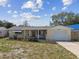 Charming single-story home featuring a one car garage and covered front porch at 3514 Truman Dr, Holiday, FL 34691