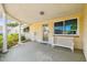 Welcoming front porch with a bench, decorative columns, and a stylish entrance door at 3514 Truman Dr, Holiday, FL 34691