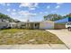 Charming single-story home featuring a covered porch, attached garage, and well-manicured lawn at 3514 Truman Dr, Holiday, FL 34691
