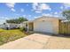 A single-Gathering home with a well-kept lawn, an attached garage, and covered front porch at 3514 Truman Dr, Holiday, FL 34691
