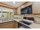 Modern kitchen featuring a stove and stainless steel microwave at 3514 Truman Dr, Holiday, FL 34691