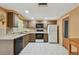 Spacious kitchen featuring tile floors, modern appliances, and abundant natural light at 3514 Truman Dr, Holiday, FL 34691