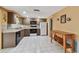 Well-lit kitchen with tile floors, ample counter space, and modern appliances at 3514 Truman Dr, Holiday, FL 34691