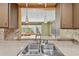 Close up of the kitchen featuring stainless steel sink and a view to the dining area at 3514 Truman Dr, Holiday, FL 34691