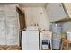 Functional laundry area with washer, utility sink, water heater, and overhead storage at 3514 Truman Dr, Holiday, FL 34691