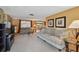 Inviting living room featuring comfortable sofas, carpet flooring, and natural light at 3514 Truman Dr, Holiday, FL 34691