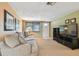 Well-lit living room with a sofa, entertainment center, and a cozy atmosphere at 3514 Truman Dr, Holiday, FL 34691