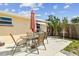 Relaxing patio space with a dining set, grill, and manicured landscaping at 3514 Truman Dr, Holiday, FL 34691