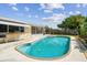 View of a backyard in-ground private pool and patio area with the home in the background at 3514 Truman Dr, Holiday, FL 34691