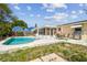 Backyard private pool with patio, sunroom, and a grill at 3514 Truman Dr, Holiday, FL 34691