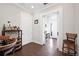 Stylish bar area with wine rack, bar stools, and direct access to the entryway, offering a perfect space to relax and unwind at 4405 Barletta Ct, Wesley Chapel, FL 33543