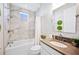 Stylish bathroom showcases a tub, neutral walls, vanity with decorative plants, and modern fixtures for a spa-like experience at 4405 Barletta Ct, Wesley Chapel, FL 33543
