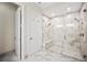 Elegant shower featuring a built-in bench, multiple showerheads, and glass door at 4405 Barletta Ct, Wesley Chapel, FL 33543