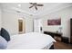 Large bedroom with hardwood floors, bright lighting and a ceiling fan at 4405 Barletta Ct, Wesley Chapel, FL 33543