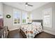 Bright bedroom with ample natural light, decorative wreaths, and a colorful quilt, creating a cozy and inviting atmosphere at 4405 Barletta Ct, Wesley Chapel, FL 33543