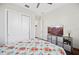 Comfortable bedroom features a floral quilt, television, ample storage, and neutral walls, providing a relaxing retreat at 4405 Barletta Ct, Wesley Chapel, FL 33543
