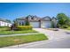 Stunning home exterior with a paved driveway, well-manicured lawn, and a three car garage at 4405 Barletta Ct, Wesley Chapel, FL 33543