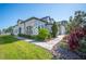 Beautiful townhome with stone and stucco facade, complemented by manicured landscaping and walkway to entrance at 4405 Barletta Ct, Wesley Chapel, FL 33543