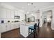 Stylish kitchen features a granite island with seating, modern appliances, and ample white cabinet storage at 4405 Barletta Ct, Wesley Chapel, FL 33543