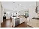 Open floor plan showcasing a kitchen island with stainless steel dishwasher and hardwood flooring at 4405 Barletta Ct, Wesley Chapel, FL 33543