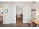 Home office featuring sliding barn doors, hardwood floors, and ample natural light creating the ideal space for working from home at 4405 Barletta Ct, Wesley Chapel, FL 33543