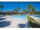 Large community pool with palm trees and plenty of seating, perfect for relaxation and enjoying the Florida sunshine at 4405 Barletta Ct, Wesley Chapel, FL 33543