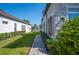 Manicured lawn with walkway between the townhome and the adjacent white home at 4405 Barletta Ct, Wesley Chapel, FL 33543