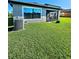 A lush green yard with a screened patio at 5154 Brickwood Rise Dr, Wimauma, FL 33598