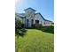 Side view of house showcasing landscaping and stone column feature at 5154 Brickwood Rise Dr, Wimauma, FL 33598