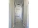 Light and airy hallway with neutral paint and ceramic tile at 5154 Brickwood Rise Dr, Wimauma, FL 33598