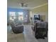 Bright living room features tile floors, large windows, and neutral paint to complement any decor at 5154 Brickwood Rise Dr, Wimauma, FL 33598