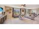 Bright living room with neutral tones, stylish furnishings, and a ceiling fan at 5527 Warrington Town Path, Wesley Chapel, FL 33545