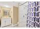 Fresh bathroom featuring a modern vanity, stylish shower with tile, and a colorful shower curtain at 602 Stephens Rd, Ruskin, FL 33570