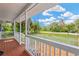 Charming front porch with wooden floors and railings, offering scenic views of the surrounding landscape at 602 Stephens Rd, Ruskin, FL 33570