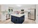 Modern kitchen with white cabinets, stainless steel appliances, and a central island at 602 Stephens Rd, Ruskin, FL 33570