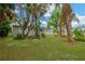 Lush lawn, tropical trees, and garden beds enhance the curb appeal of this inviting home at 602 Stephens Rd, Ruskin, FL 33570