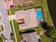 An aerial view shows the home's private pool, backyard with beautiful water view, and driveway at 6056 Fall River Dr, New Port Richey, FL 34655