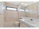 Neutral bathroom with tile walls, shower-tub combo, and sink with a large mirror at 6056 Fall River Dr, New Port Richey, FL 34655