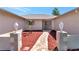 Inviting walkway leading to double doors with decorative glass and landscaped front yard at 6056 Fall River Dr, New Port Richey, FL 34655