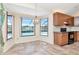 Kitchen featuring tile flooring, wooden cabinets, and a view of the pool through the window at 6056 Fall River Dr, New Port Richey, FL 34655