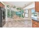 Eat-in kitchen with mural painted on the wall, tile floors, and a pool view from the window at 6056 Fall River Dr, New Port Richey, FL 34655