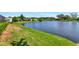 Green lawn and lake view from a residential neighborhood at 6056 Fall River Dr, New Port Richey, FL 34655