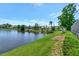 Green lawn meets the water in this backyard lake view at 6056 Fall River Dr, New Port Richey, FL 34655