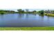 Wide shot of a lake in a residential neighborhood at 6056 Fall River Dr, New Port Richey, FL 34655