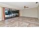 Living room with tile flooring and sliding glass doors to screened patio, enhancing natural light at 6056 Fall River Dr, New Port Richey, FL 34655