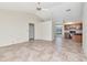 Open living area with tile flooring, ceiling fan, and view into adjacent kitchen area at 6056 Fall River Dr, New Port Richey, FL 34655
